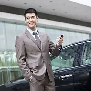 Young Chinese businessman and cellphone