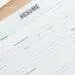 panoramic shot of glasses, calculator and resume templates on wo