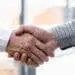 Close up of employer is shaking hands to congratulate with the n
