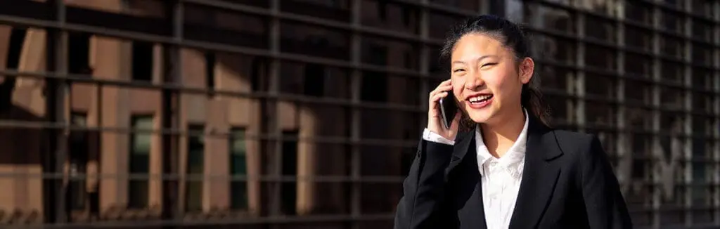 asiatic businesswoman walking talking by phone