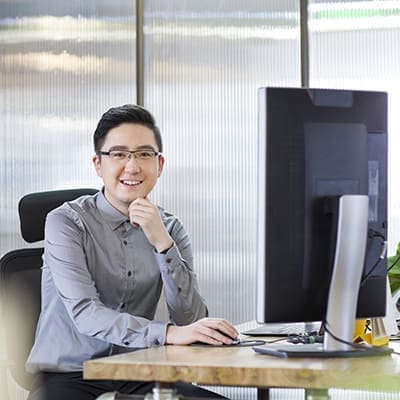 Chinese IT worker sitting in office